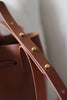 Detailaufnahme des Lederriemens mit Messing-Patronenverschlüssen